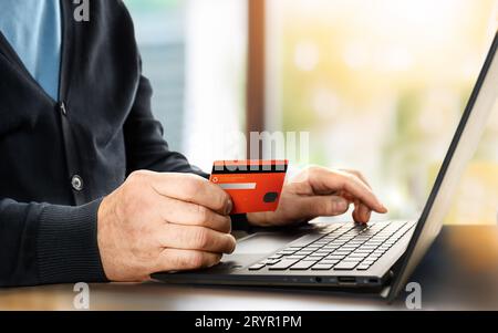 Man holding credit card and using laptop. Online shopping Stock Photo