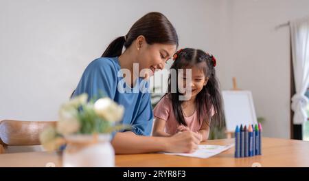 Mother and her daughter draw in the paper together, Leisure activities, holiday Stock Photo