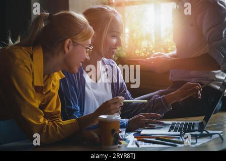 Group of colleagues having meeting in boardroom while working on big presentation and preparing their business strategy. Stock Photo