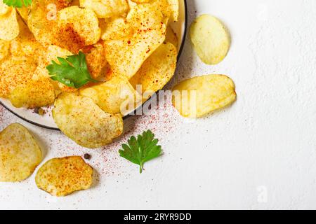 Crispy potato chips on a plate on a white background Stock Photo