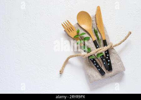 Set of bamboo cutlery and napkin on a white background. Natural Stock Photo