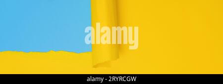 Long banner with ripped paper. Abstract torn Paper banner in yellow and blue colors with copy space. Torn Paper with space for text with blue Stock Photo