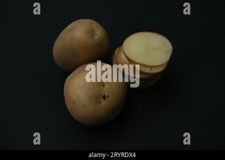Tawo Potato and one sliced ,isolated on black background. Harvest new Stock Photo