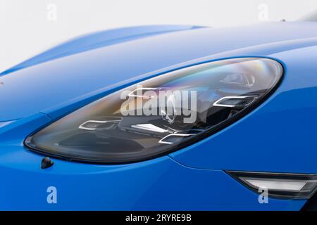 close up view of a LED headlight from a porsche 718 cayman gts, blue, in a studio, landscape view. Stock Photo