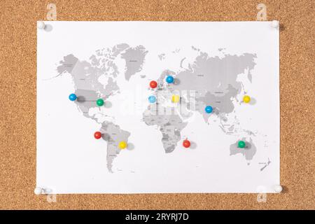Planning Travel destination concept. Pushpins on world map on Corkboard Stock Photo