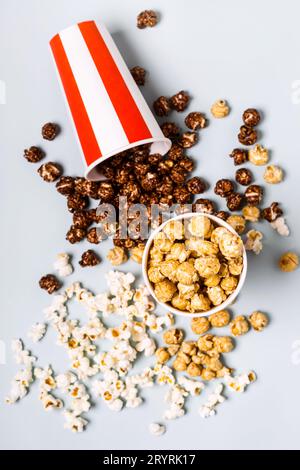 Assorted popcorn set in paper striped white red cup. Sweet and salty popcorn Stock Photo