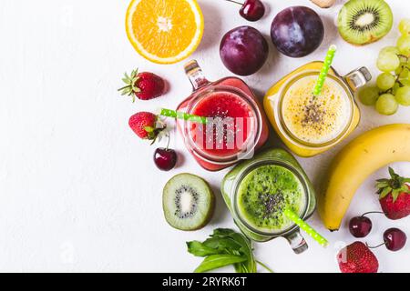 Selection of multicolored fruit smoothies  in glass jars. Stock Photo