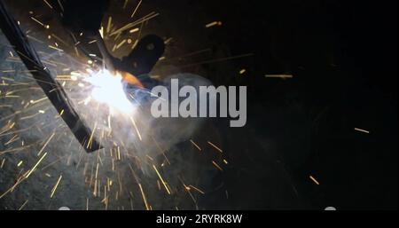 Welding robots movement in a car factory. Industrial welding robots movement in a car factory Stock Photo
