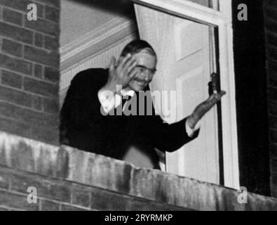 NEVILLE CHAMBERLAIN (1869-1940) British Prime Minister,  waves to crowds from No 10 Downing Street on the evening of 30 September 1938 after his return from Munich. Stock Photo