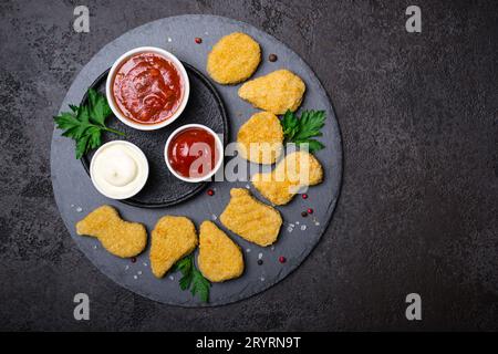 Fried crispy chicken nuggets with popular sauces, copy space Stock Photo