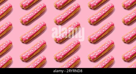 Seamless food creative texture or background. Eclairs pattern with pink icing and stars sprinkled on pink background Stock Photo