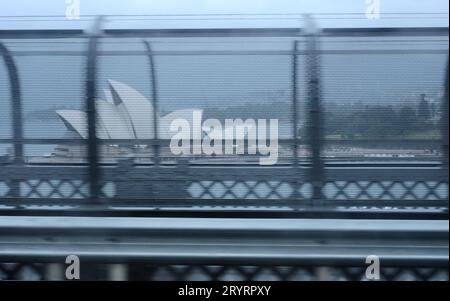 A commuters view of Sydney Opera House seen from a moving train crossing the Harbour Bridge Stock Photo