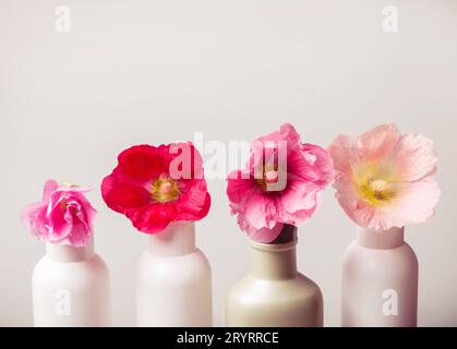 Natural Cosmetics set and flowers on gray background Stock Photo