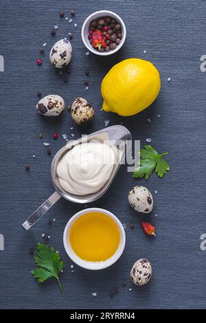Mayonnaise sauce and ingredients on blue cloth background Stock Photo