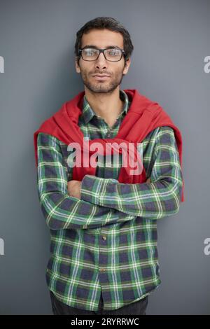 Stylish young man posing in the studio on gray background Stock Photo