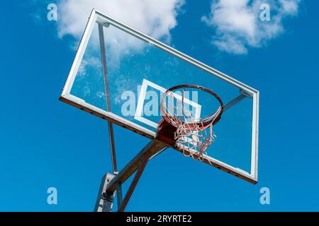 Basketball hoop on wooden backboard against overcast sky · Free Stock Photo