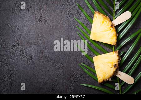 Ripe Pineapple slices on a black background Stock Photo