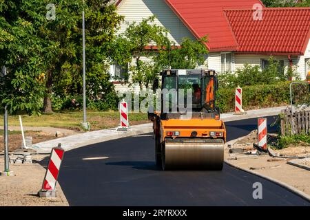 Construction site is laying new asphalt pavement Stock Photo