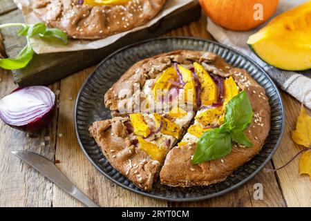 Homemade galette pie or crostata with pumpkin and ricotta cheese on rustic  background. Thanksgiving day food. Stock Photo