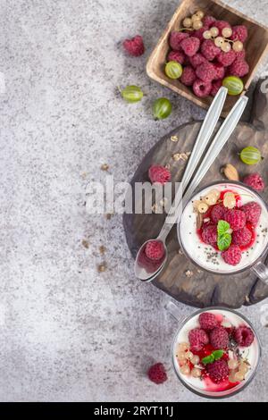 Fresh raspberry berries with yogurt or cream in glasses. Summer Breakfast Dessert Concept Stock Photo