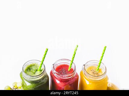 Selection of multicolored fruit smoothies  in glass jars. Stock Photo