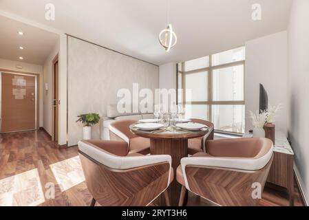 Living room of newly renovated apartment with wooden furniture with upholstered chairs Stock Photo