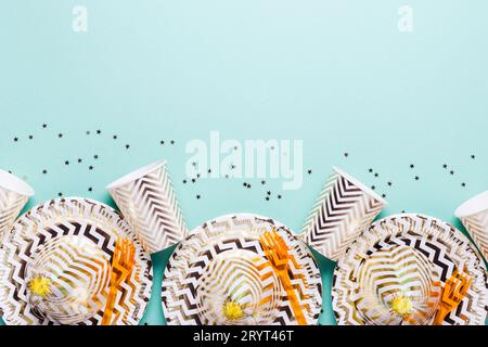 Festive accessories for party in gold tones on turquoise background Stock Photo