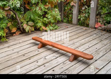 Persian shena push up board on a backyard wooden deck in fall scenery Stock Photo