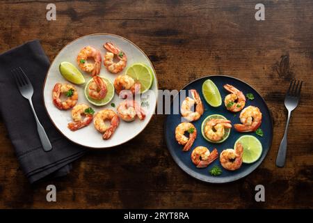 Shrimps, overhead flat lay shot. Fried shrimp with lime, two plates Stock Photo