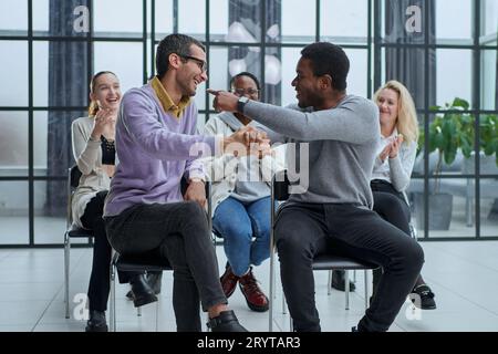 happy friendly diverse professionals, teachers and students giving high five while Stock Photo