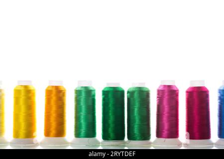 set of different color sewing threads, isolated on white background. Stock Photo