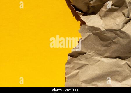 A piece of paper on a yellow background. Crumpled Paper Wallpaper.crumpled paper sheet. Stock Photo