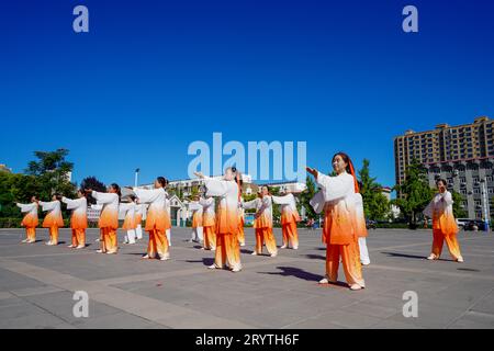 Luannan County, China - August 22, 2023: qigong performance is performed on a square. Stock Photo