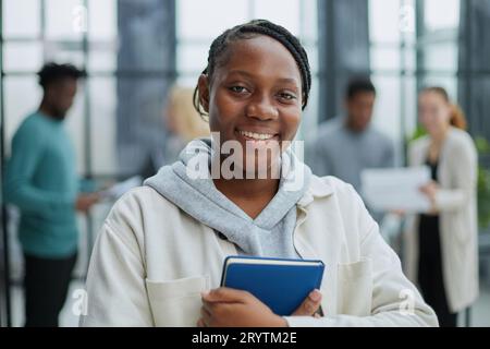 Female African American job seeker keeping a folder with CV Stock Photo