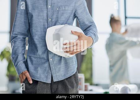 Close-up of a man holding a helmet in white Stock Photo