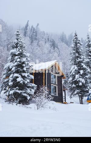 House in fir forest Teletsky Altai winter mountain ski resort Stock Photo