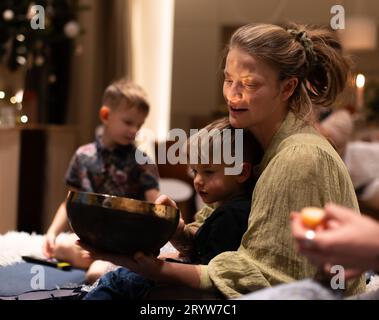 A cheerful family of three is bonding while enjoying a fun game together Stock Photo
