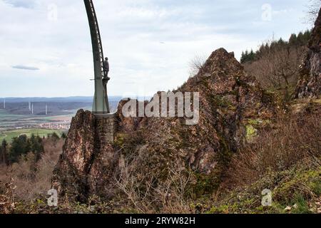 Donnersberg, Germany - April 9, 2021: Statue of man on the side of Adlerbogen, Eagle Arch, built in rocks on a hill on a spring day in Germany. Stock Photo