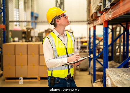 Warehouse workers talking together checking goods in storage Stock Photo