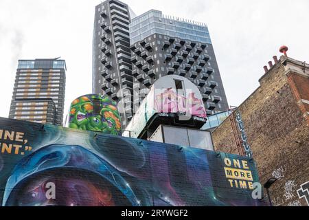 Disused Tube trains which form part of Lets adore and endure each other art installation, above Holwell Lane in Shoreditch East London. Stock Photo