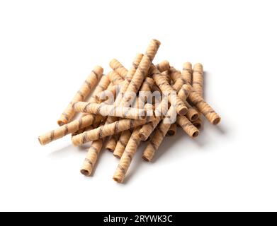 Crispy wafer rolls with chocolate cream are folded into a beautiful pile on a white background. Pile of crispy wafer sticks with chocolate filling Stock Photo