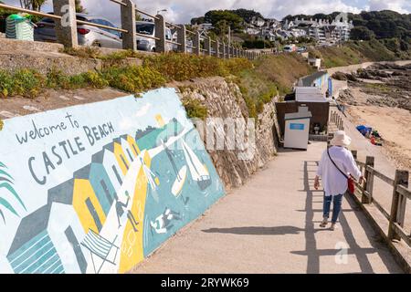 Falmouth Cornwall, model released woman walks down ramp to Castle Beach,Cornwall,England,UK Stock Photo
