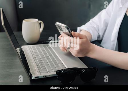 Professional Businesswomen Multitasking with Laptops and Smartphones in Modern Office. Diverse Female Managers Engaged in Internet Marketing at Office Stock Photo