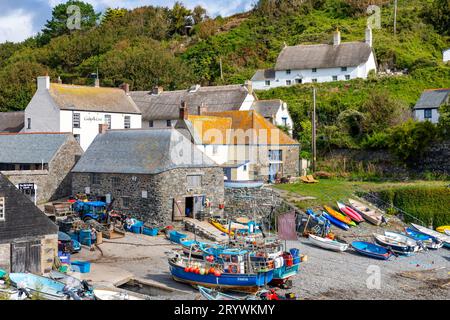 Cadgwith a Cornish village on the Lizard Peninsula is a small fishing port with fishing vessels boats on the working harbour beach, England,UK Stock Photo