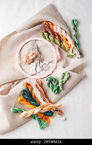 Embroidery set. Linen fabric, embroidery patterns, embroidery hoop, colorful threads and needls. Stock Photo