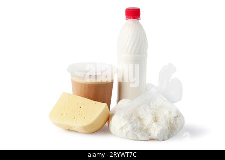 Still life with dairy products on a white background: milk in a plastic bottle, cottage cheese in a plastic bag, fermented baked milk in a plastic con Stock Photo