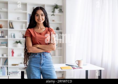 Portrait of confident young indian woman posing at home office Stock Photo