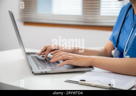 Medical technology network team meeting concept. doctor hands typing on keyboard laptop computerÂ Stock Photo