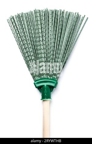 Green plastic broom with wooden handle for street cleaning isolated on white background Stock Photo