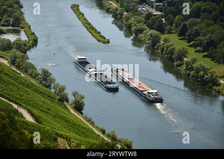 Bird's eye view of two barges on the Moselle loop surrounded by greenery and vineyards in Germany Stock Photo